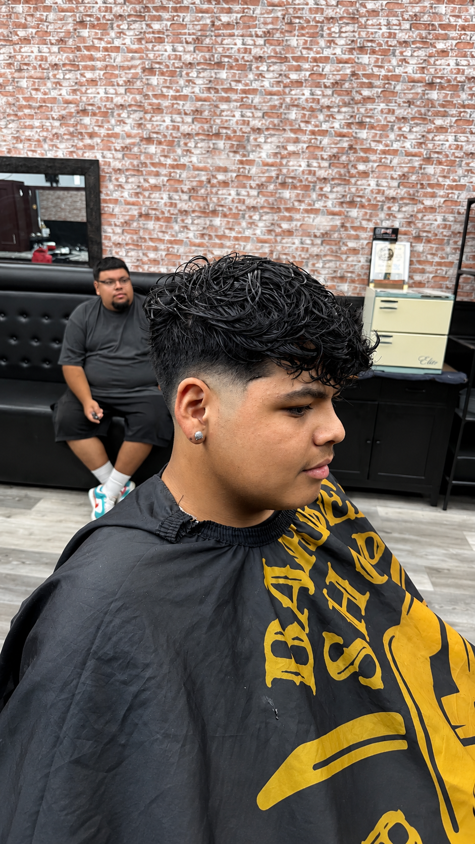 Curly textured top with mid drop fade