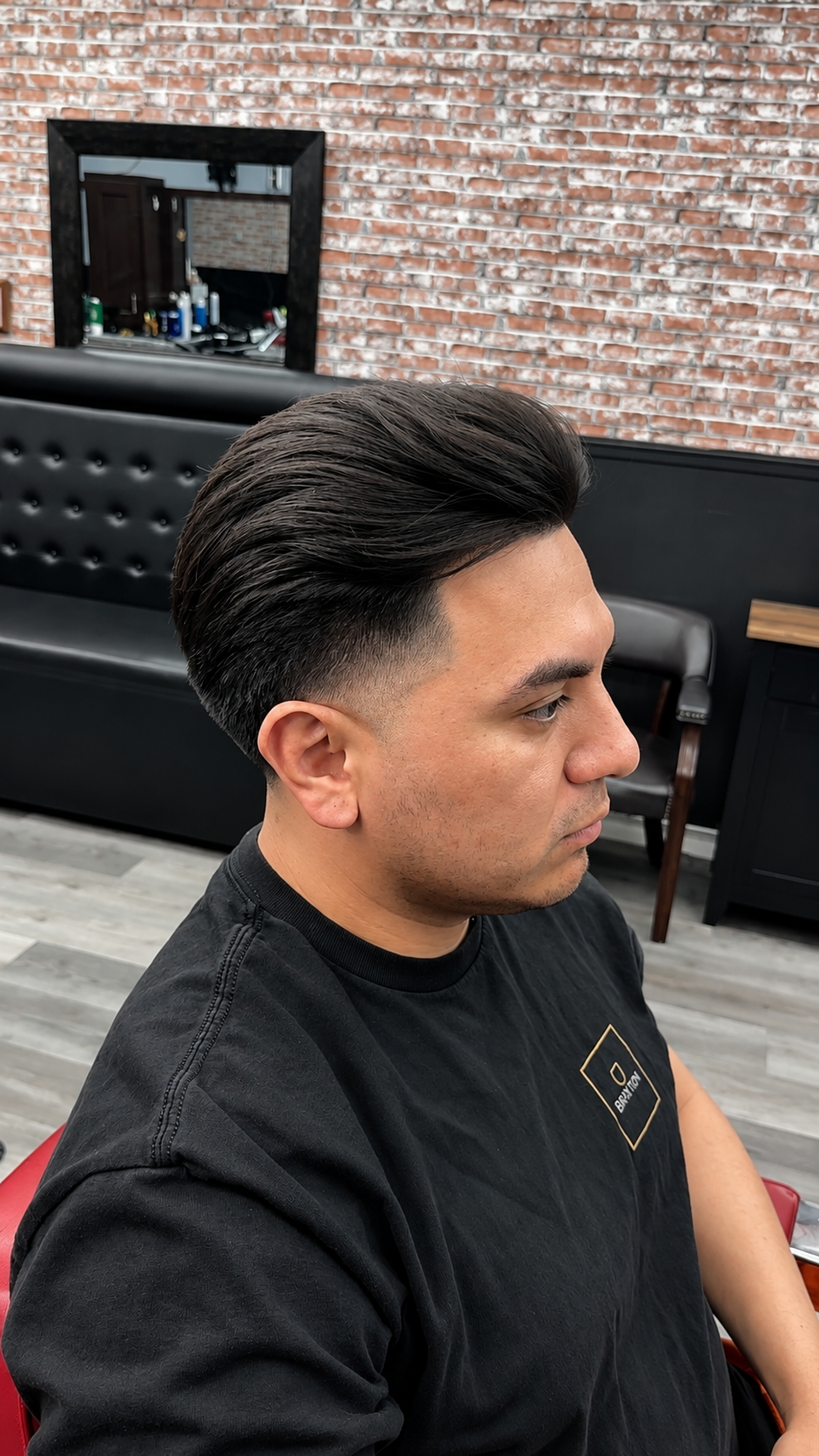 Slick back pompadour with low taper fade