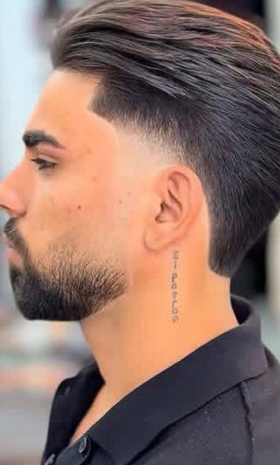 Slick back with hard part line and beard fade