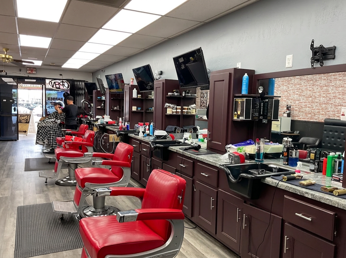 Inside Dapper Cuts Barbershop — row of classic red barber chairs and stocked stations