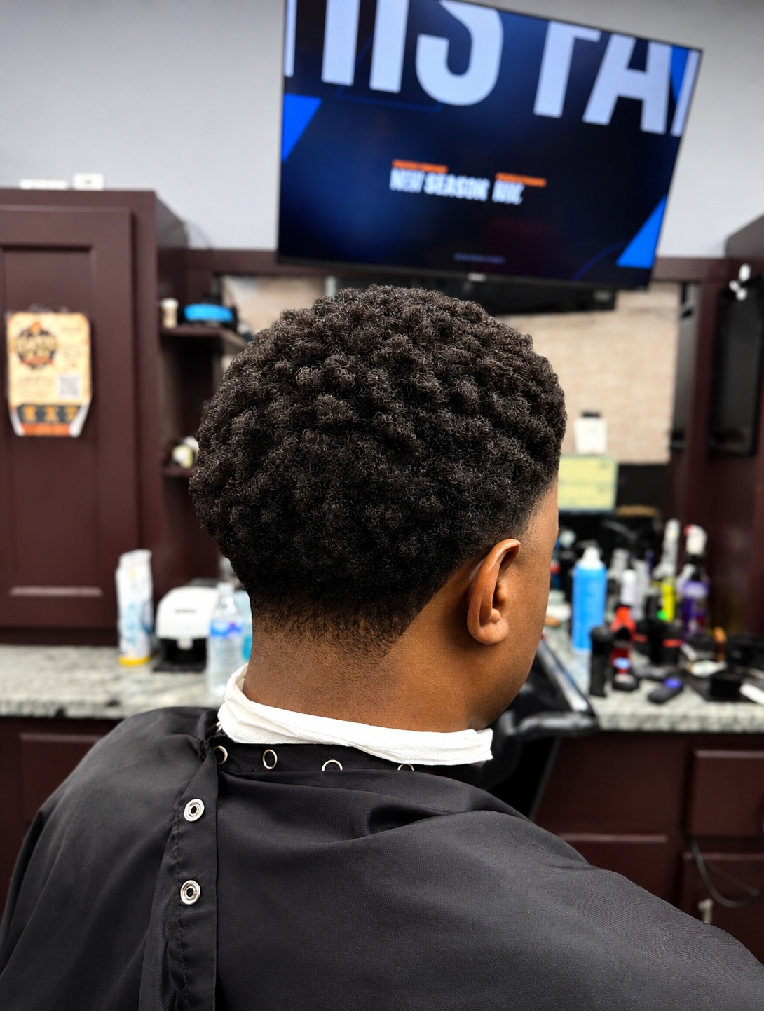 Curly sponge twist with taper fade — back view