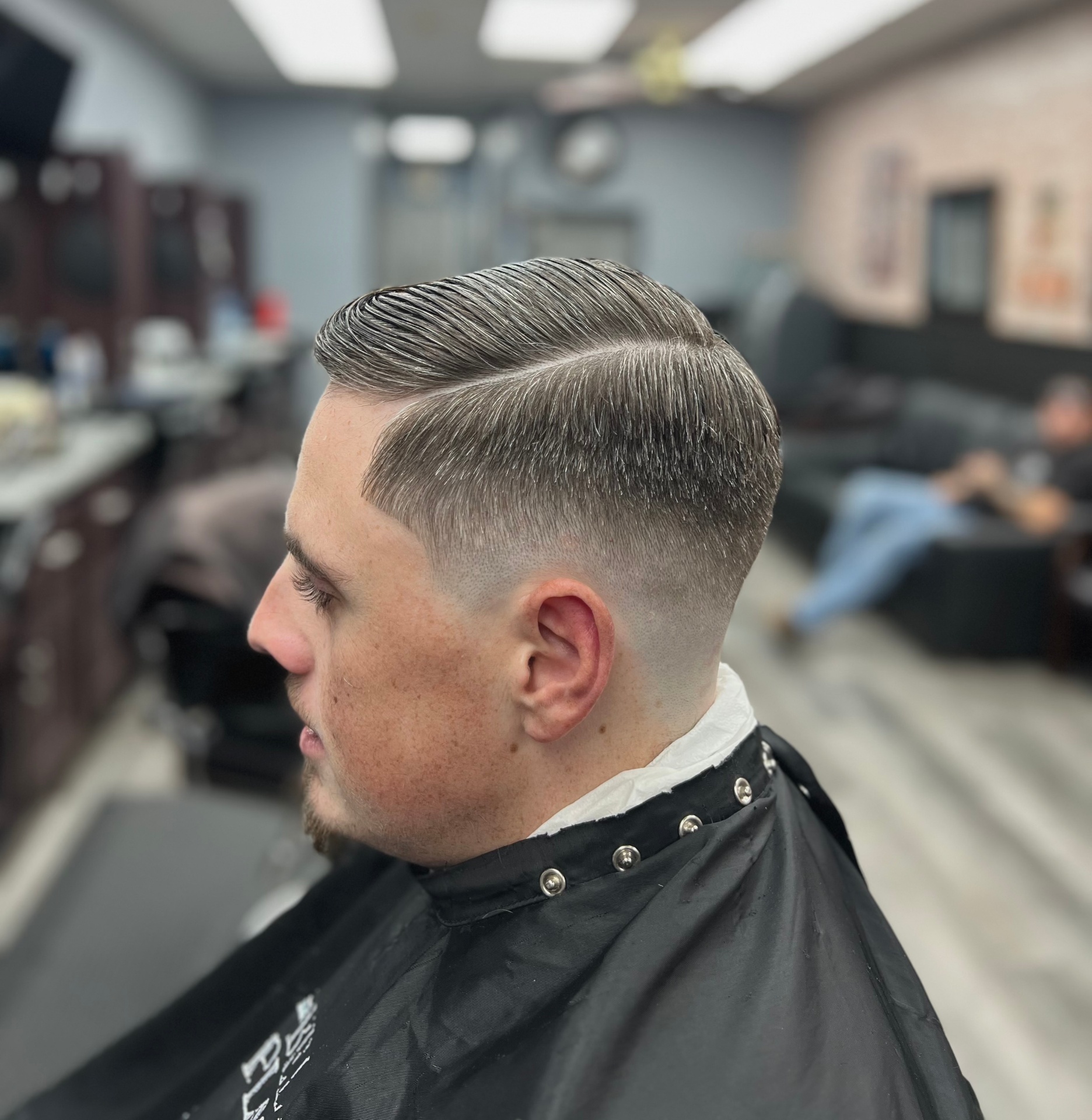 Skin fade with sharp side part